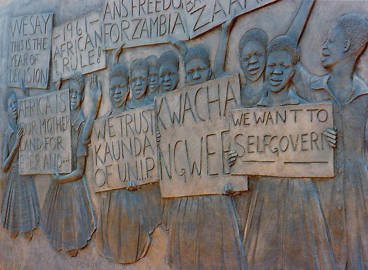 A carved wooden mural in Livingstone, Zambia, promoting Zambian and African self-governance